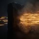 Bundle of amber light streaks hurled at high speed against a dark stone monolith that does not move an inch, the streaks bursting into sparks against its face while a few pass beyond it into the dark meeting nothing