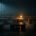 Vast deserted open-plan office at night, rows of empty desks fading into darkness and a single desk lit by an amber lamp, an image of the frozen American labour market