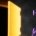 The trader of the future with the amber and violet visor looks at a monumental glowing vault door which, seen from the side, turns out to be a paper thin panel standing on nothing, with emptiness behind it